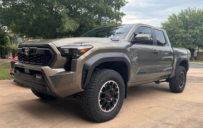 Amazing what a tint, tires, and chin tuck will do to these trucks (265/70 R18 Falken Wildpeak A/T4 installed)